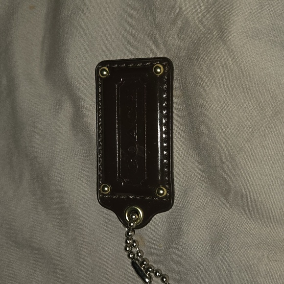 Coach bag charm in brown and has gold rivets. EUC  NO CALL OUTS - Picture 1 of 2